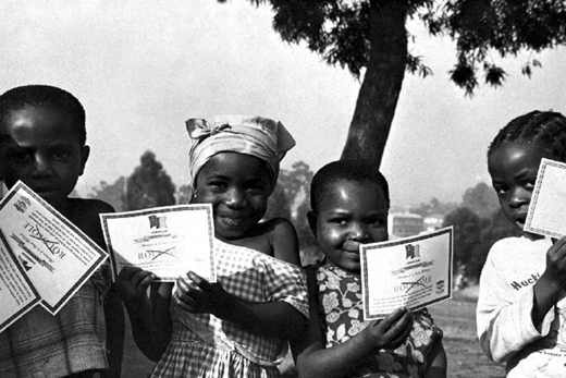 Children stand with their smallpox vaccination certificates in Cameroon in January 1975.