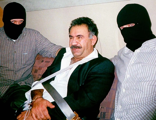 Turkish special forces flank a bound and handcuffed Abdullah Ocalan, who was captured in Kenya on February 16, 1999. Ocalan was flown to Turkey, where he was convicted of treason. 