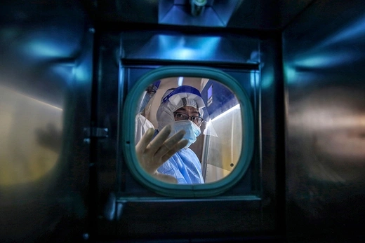 A medical worker stands inside an isolation ward at a hospital in Wuhan, China, in March 2020.