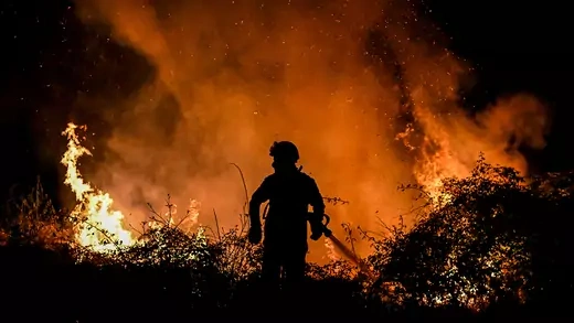 A firefighter fights a forest fire in the north of Portugal, on July 15, 2022.