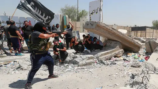A supporter of Muqtada al-Sadr fires at security forces in Baghdad’s Green Zone.