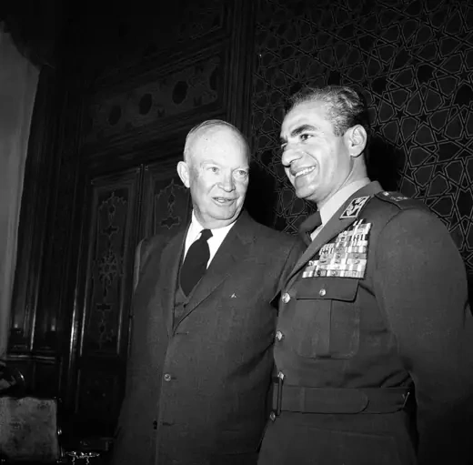 President Dwight Eisenhower speaks to a smiling Shah Mohamed Reza Pahlavi 