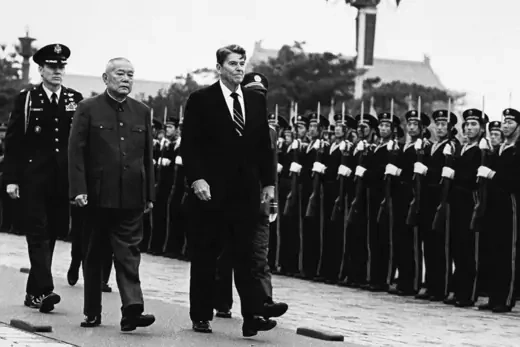 President Ronald Reagan and Chinese President Li Xiannian review the military honor guard in Beijing