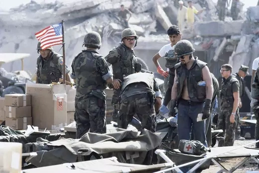 A group of American soldiers stands amid the debris of the U.S. embassy in Beirut