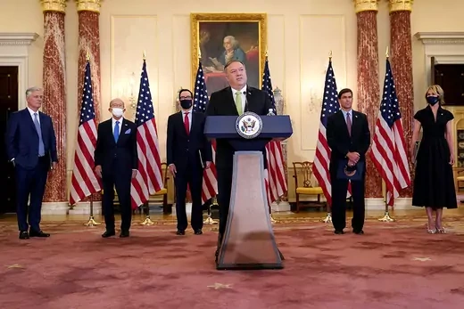 U.S. Secretary of State Mike Pompeo is flanked by other officials while announcing the restoration of sanctions on Iran