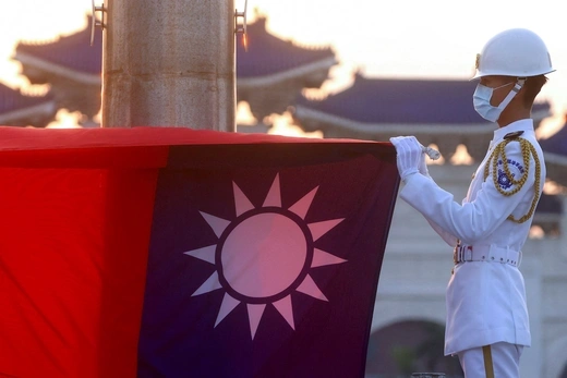 Honor guards lower the Taiwan flag during sunset hours at Liberty Square in Taipei.