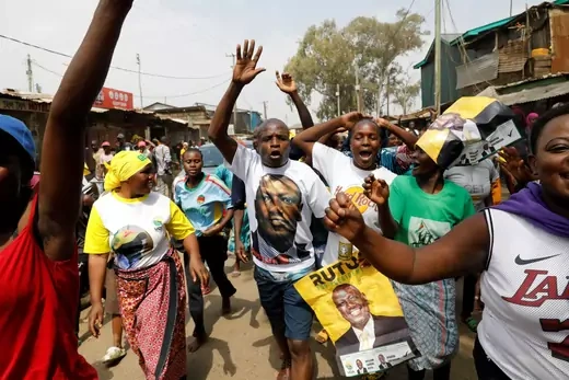 A group of supporters of Kenya's President-elect William Ruto hold yellow campaign signs as they celebrate his win being upheld by the Supreme Court.