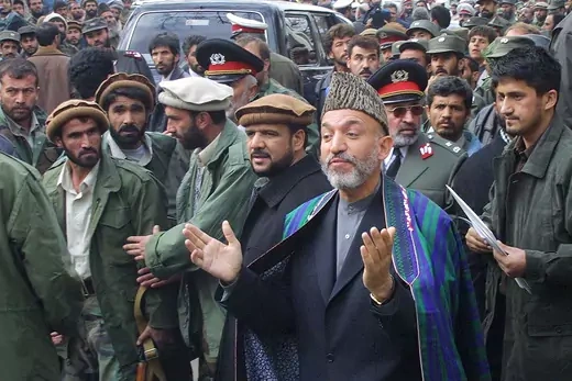 Hamid Karzai surrounded by crowd in Kabul.