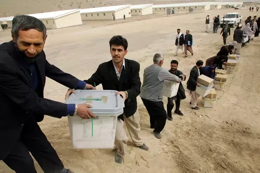 Afghan election officials pass presidential election ballots.