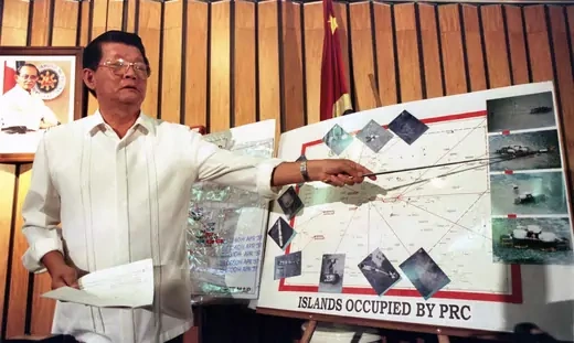 Former Philippine Secretary of National Defense Renato de Villa points out a Chinese-built structure in the disputed Spratly Islands.