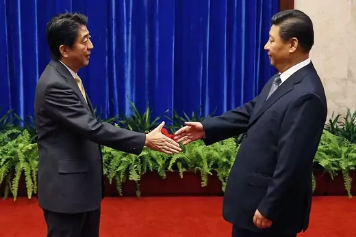 China’s Xi Jinping and Japan’s Abe Shinzo shake hands at the APEC summit