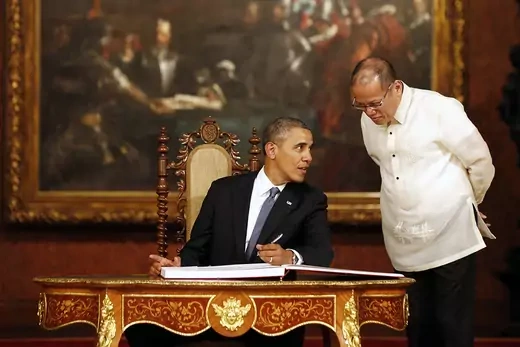 U.S. President Barack Obama talks with Philippine President Benigno Aquino in Manila. 