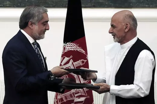 Abdullah Abdullah and Ashraf Ghani exchange signed agreements to form a unity government.