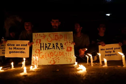 Afghan nationals, members of the Hazara minority hold placards and candles as they protest against the suicide attack at a tutoring center in west Kabul, outside the United Nations High Commissioner for Refugees (UNHCR) office, in New Delhi, India, September 30, 2022.