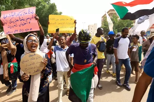 Carrying colorful posters and Sudan's green, red, black, and white striped flag, protesters march at an anti-coup rally in Khartoum, Sudan. 