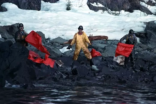 Cleaning crews attempt to restore an oil-laden beach on Prince William Sound in the wake of the Exxon Valdez disaster.