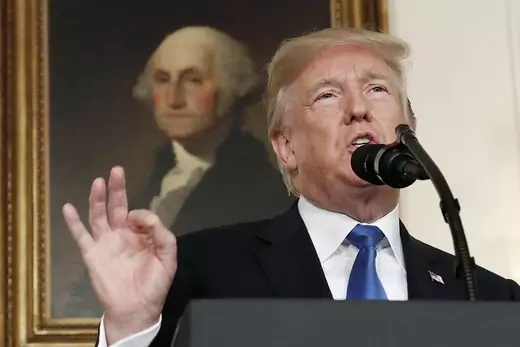 Trump speaks about the Iran nuclear deal in front of portrait of George Washington.