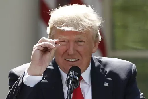 Trump gestures as he refers to the magnitude of global climate change as he announces his decision to withdraw the United States from the landmark Paris climate agreement.
