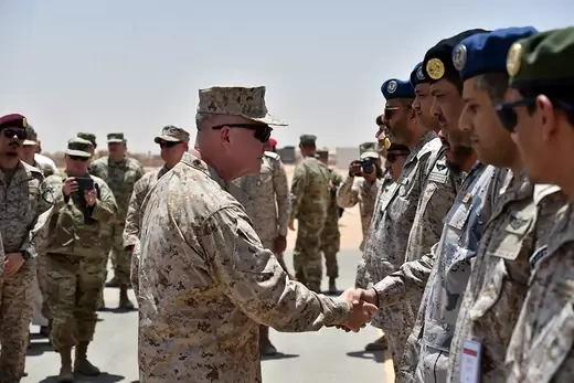 General Kenneth McKenzie, commander of U.S. Central Command, greets Saudi military officers during a 2019 visit to Saudi Arabia.