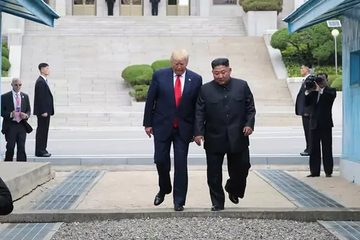 Trump and Kim step across the border between North and South Korea.