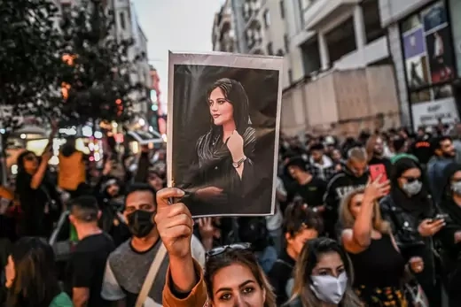 A protester holds a portrait of Mahsa Amini during a demonstration in support of Amini, a young Iranian woman who died after being arrested in Tehran by the Islamic Republic's morality police, on Istiklal avenue in Istanbul on September 20, 2022