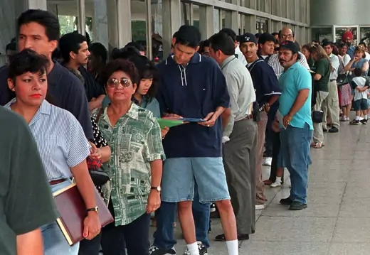 A group of immigrants, who qualify for residency in the United States but do not yet have their legal papers, stand in line at the Immigration and Naturalization Service offices in Los Angeles. 