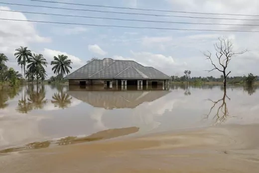 A building is pictured submerged and surrounded by water following a large flood.