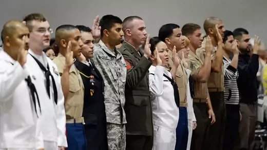 Several members of U.S. armed forces take the oath of citizenship at a naturalization ceremony at the Los Angeles Convention Center on June 27, 2012 in Los Angeles, California.