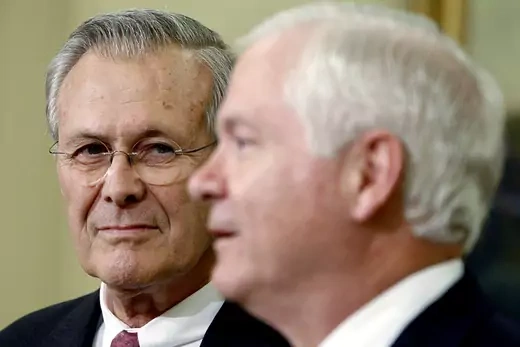  Close up of Donald Rumsfeld looks looking on while Robert Gates speaks.