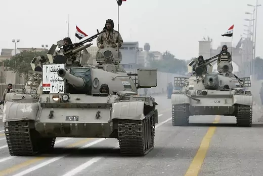 Iraqi soldiers drive tanks during a handover ceremony in Basra.