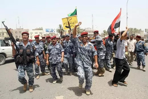 Iraqis police and soldiers celebrate on the streets of the southern city of Basra as US troops withdraw from Iraqi towns and cities.