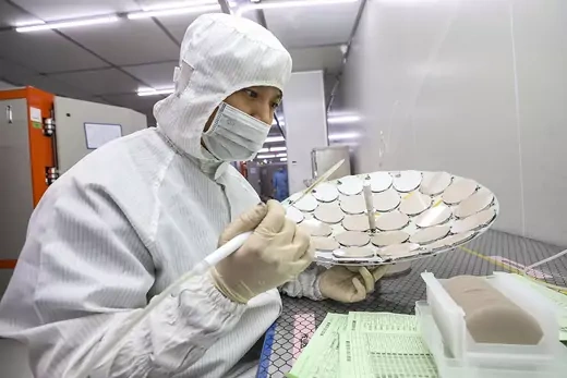  An employee works on a production line for semiconductor wafers at a factory in Huai’an, China.