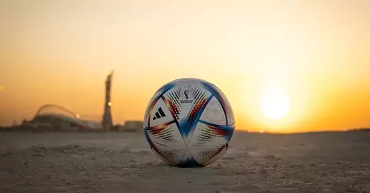 World Cup soccer ball in a desert field.