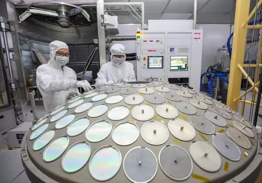 Employees work on the production line of semiconductor wafer at a factory of Jiangsu Azure Corporation Cuoda Group Co., Ltd. on September 27, 2022 in Huai'an, Jiangsu Province of China