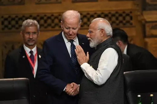 U.S. President Biden and PM Modi shake hands and speak at the G20 opening session on November 15, 2022. 