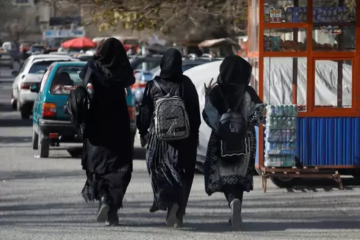 Afghan female students walk near Kabul University in Kabul, Afghanistan, December 21, 2022.