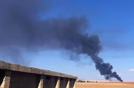 Smoke rises from a field near the Syrian town of al-Qahtaniyah 