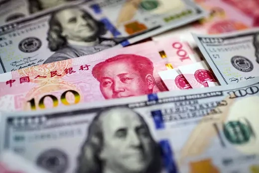 Chinese 100 yuan banknotes and U.S. $100 notes