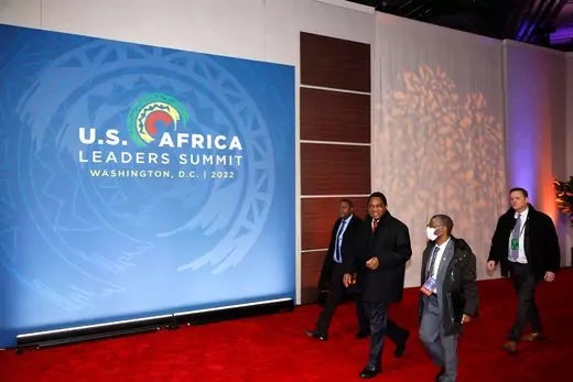 President of Zambia Hakainde Hichilema passes a blue banner for the US-Africa Business Forum in Washington, DC.  