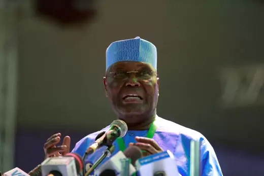 Former Nigeria Vice President Atiku Abubakar adresses the People's Democratic Party delegates while gesturing with his hands.