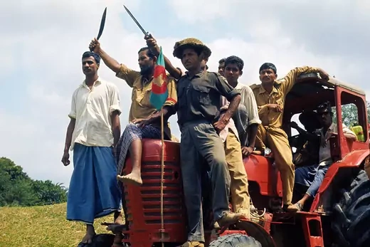 Bangladesh commandos, perched atop a tractor at the Meshila Checkpost, sing their battle song during the 1970 War for Independence.