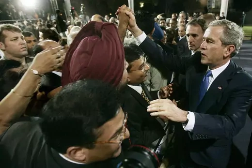 U.S. President George W. Bush greets people after a speech in New Delhi. 