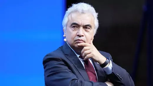Fatih Birol touches chin at event