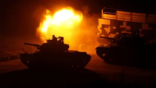 Silhouette of Taiwanese tank in front of fireball during military training exercise.