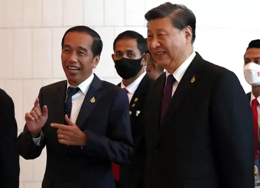 President Joko Widodo of Indonesia smiles as he speaks to Chinese President Xi Jinping.