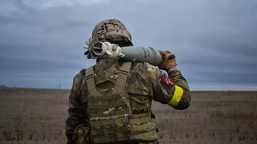 A member of Ukrainian National Guard carries a mortar shell in Kharkiv region on October 25, 2022.