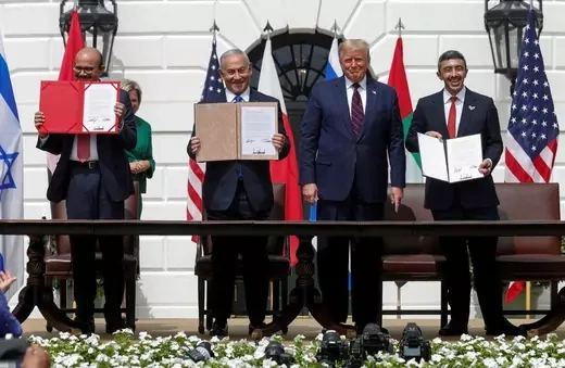 Israel's Prime Minister Benjamin Netanyahu, United Arab Emirates (UAE) Foreign Minister Abdullah bin Zayed, and Bahrain’s Foreign Minister Abdullatif Al Zayani stand at the signing ceremony for the Abraham Accords.