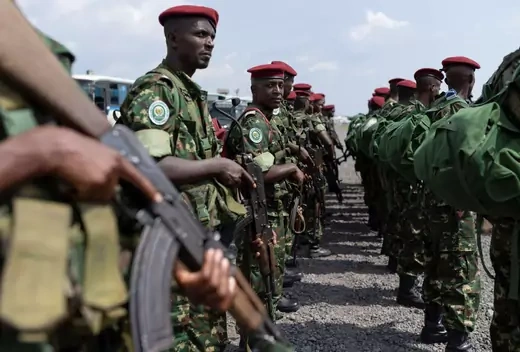 Standing in formation, Burundian soldiers in green camo fatigues with red berets arrive to their deployment at an airport in Goma, North Kivu, Democratic Republic of Congo.