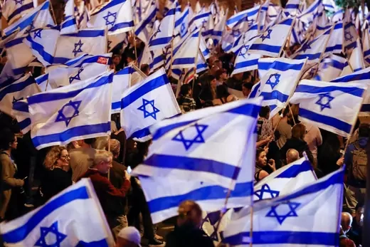 People hold Israeli flags during a demonstration as Israeli Prime Minister Benjamin Netanyahu's nationalist coalition government presses on with its contentious judicial overhaul, in Tel Aviv, Israel, March 11, 2023.