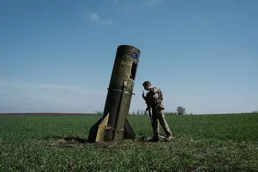 American soldier examines crashed missile.
